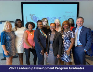 Group of 10 adults in front of sign reading Leadership Development Program